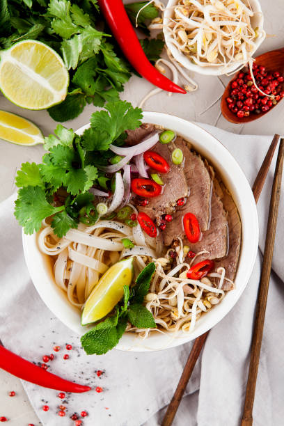 istock Vietnamese Pho Noodle Soup on light table. Beef with Chilli, Basil, Rice Noodles, Bean Shoots showing noodles 1178188573