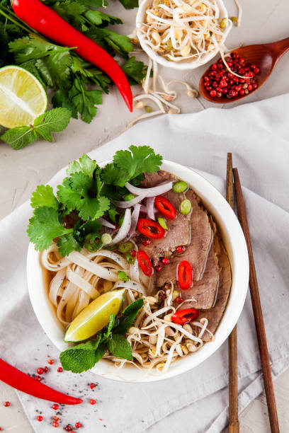 istock Vietnamese Pho Noodle Soup on light table. Beef with Chilli, Basil, Rice Noodles, Bean Shoots showing noodles 1178188625
