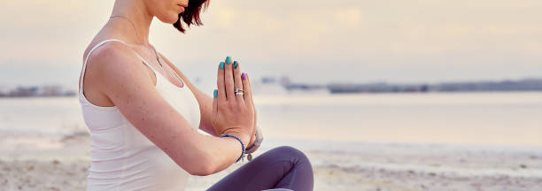 istock Woman sit in lotus pose folded hands traditional greeting Namaste 1178192000