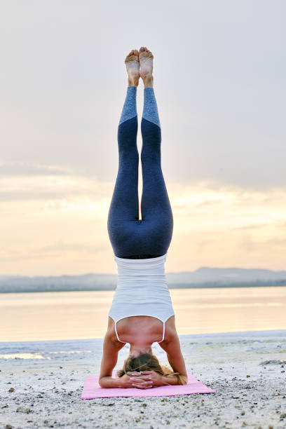 Woman doing Hatha yoga headstand