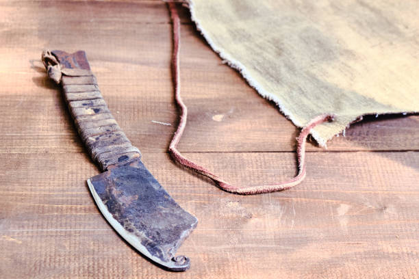 istock An old hand-made knife with a wound handle. Retro blade covered with rust on wooden table. 1178192880
