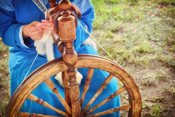 istock Distaff creates a thread from a spindle. Hand spinning wheel in nature, close-up. 1178193076
