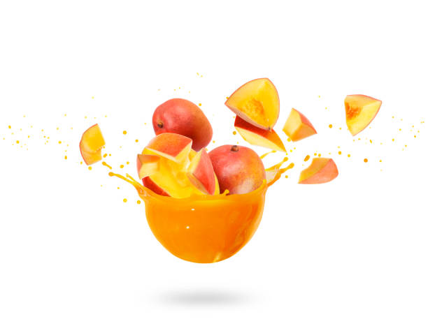 istock Whole and sliced mango with splashes of fresh juice, isolated on white background 1178193529