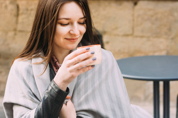 istock Young woman in a street cafe drinking coffee 1178193549