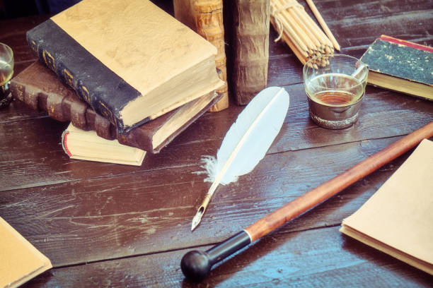 istock Books, paper and feather for writing in ink. Table with retro writing utensils. 1178194777