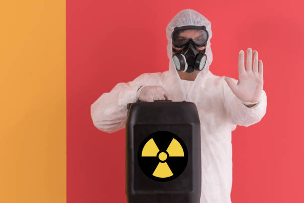Factory worker wearing gas mask and radioactive protection suit