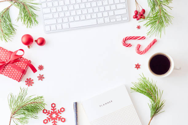 istock Flat lay christmas home office desk with pine branches and keyboard, christmas decorations  on a white background 1178196040