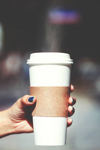 istock Disposable cup of coffee in hand with free logo space 1178196162