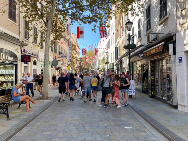 Main Street in Gibraltar Tourists and locals walking along Main Street, the main shopping area in Gibraltar gibraltar shops stock pictures, royalty-free photos & images
