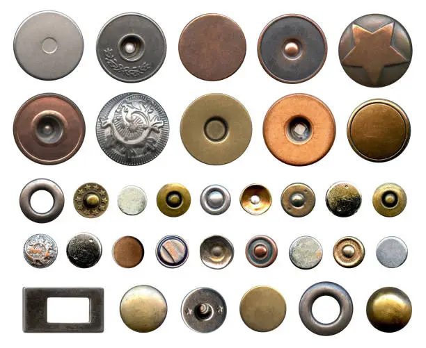 Photo of Set of different metal buttons and rivets. Vintage fushion accessories close-up isolated on a white background. Denim culcure modern style