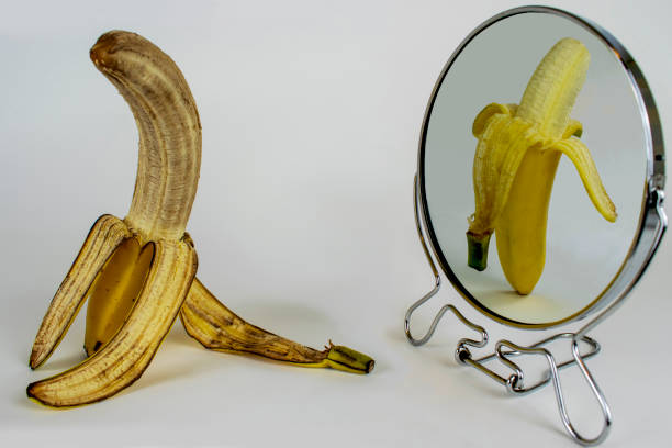Getting Old, Metaphor, Aging, Ageing, Banana in Mirror, Concept stock photo