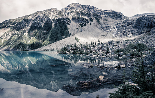 Mountain Landscape view with reflections on Upper Joffre Lake at the backcountry Campgound in British Columbia, Canada