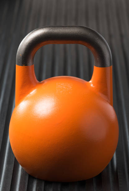 istock Orange weight training kettlebell on a gym mat 1178204334