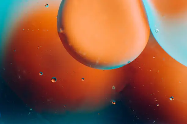 Photo of Abstract orange and blue gradient background of oil drops