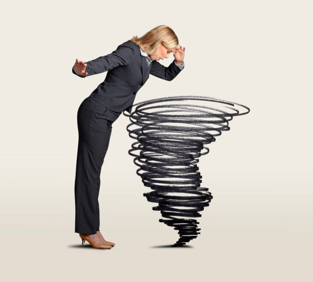 istock Businesswoman Looking Down Into A Swirling Tornado 1178208929