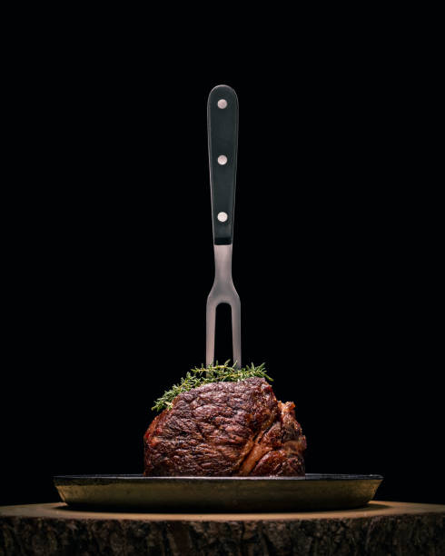 istock Sous-vide grilled beef steak with fork and herbs on dark background. 1178210381