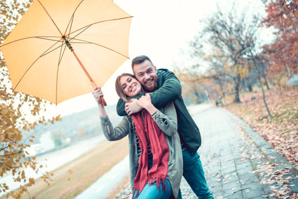 istock Couple Embracing In Park On A Rainy Day 1178210855