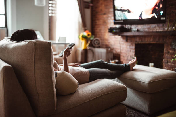 istock woman looking the tv at home 1178211896