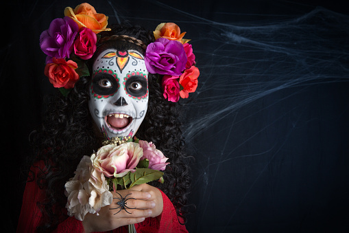 Sugar Skull little girl Halloween costume and makeup. Portrait of a little girl with Halloween costume and makeup of
