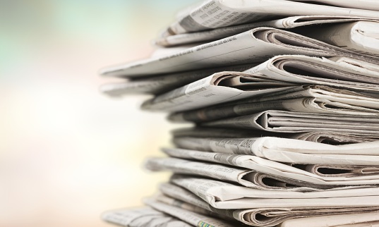 Pile of newspapers on white background