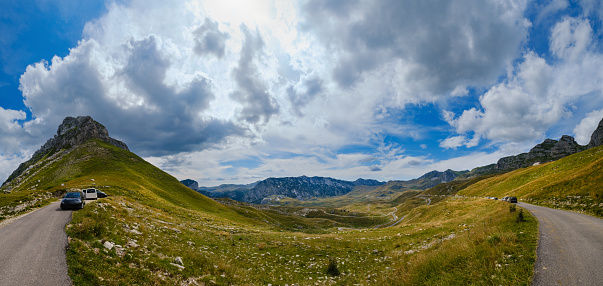 Picturesque summer mountain landscape of Durmitor National Park, Montenegro, Europe, Balkans Dinaric Alps, UNESCO World Heritage. Durmitor panoramic road, Sedlo pass. Cars unrecognizable.