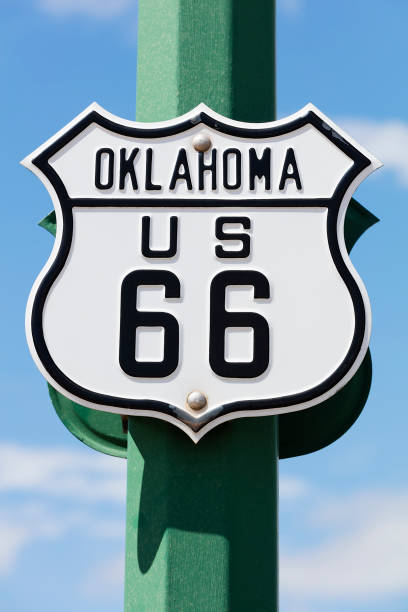 Route 66 Sign in Tulsa, Oklahoma A black and white road sign of the historic Route 66 against blue sky. route 66 sign old road stock pictures, royalty-free photos & images