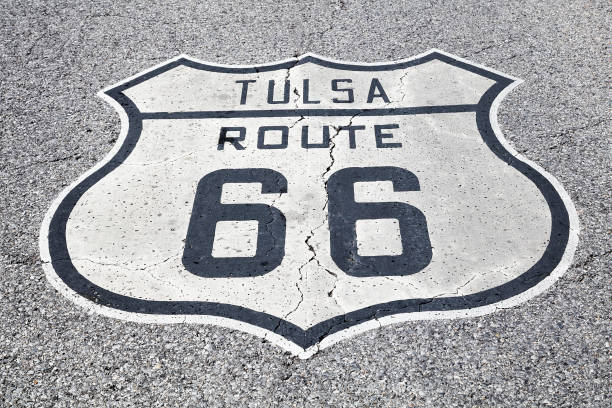 Route 66 Sign in Tulsa, Oklahoma A black and white road sign of the historic Route 66 on asphalt. tulsa landmark stock pictures, royalty-free photos & images
