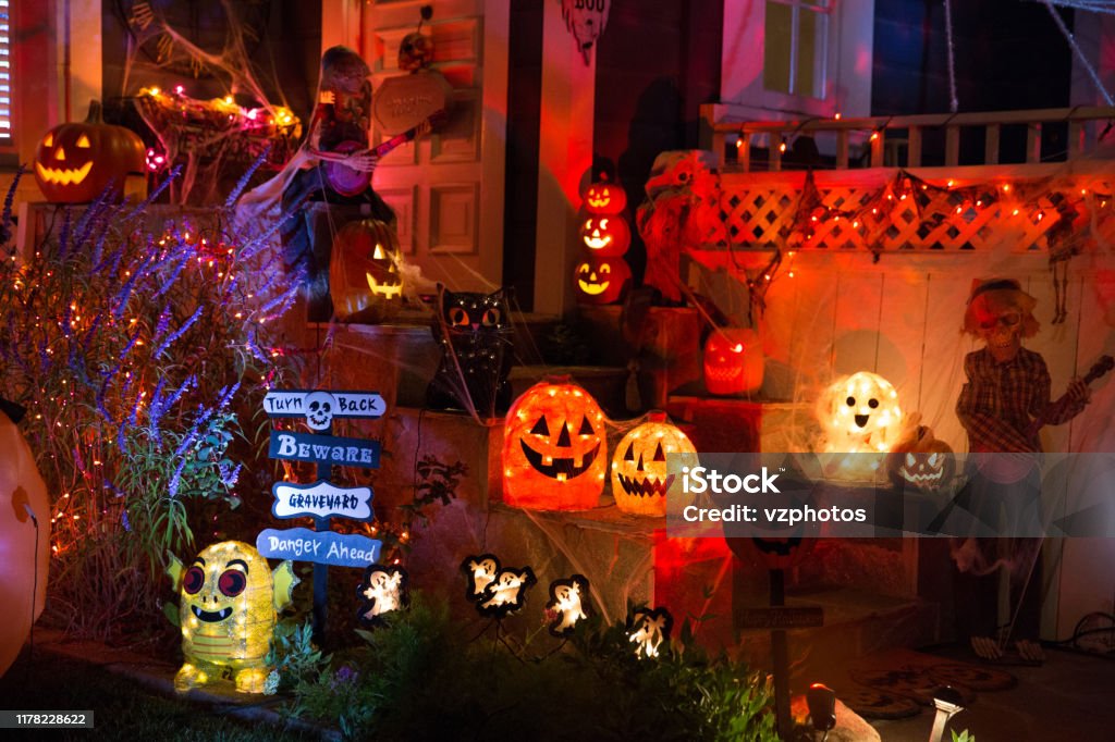 A house with Halloween pumpkins and halloween decorations at  Halloween night on a city street. Trick or treat. Halloween Stock Photo