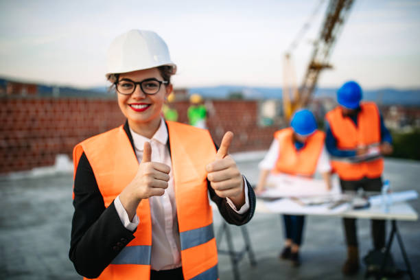 istock Confident architect woman standing at construction site 1178231179