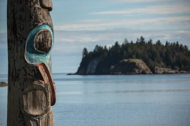 Haida Gwaii Totem poles in the British Columbia island of Haida Gwaii.  Haida poles, some of which are 300+ years old. haida gwaii totem poles stock pictures, royalty-free photos & images