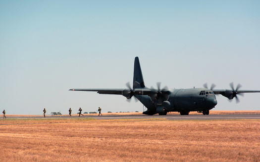 A Lockheed C-130 Hercules of the Royal Netherlands Air Force parked on a platform at the Dutch Air Force Base Eindhoven. The C-130 has a special tail decoration celebrating 25 years of service.