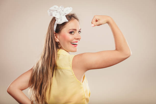 istock Happy pretty pin up girl showing off muscles. 1178242555