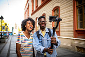 Young smiling youtubers making a video.