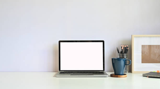 istock Copy space mockup laptop, coffee mug, pencil with photo frame on workspace desk. 1178248991