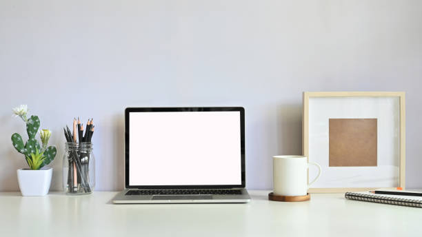 istock Workspace computer laptop, cactus, pencil, coffee and photo frame on table. 1178248998