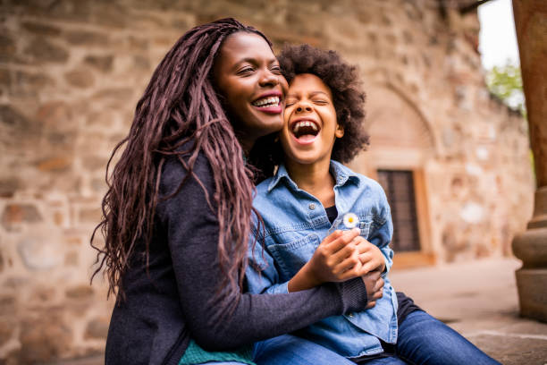 Portrait of a mid adult woman of African ethnicity and her two twin daughters.