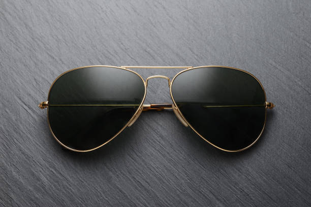 Classic sunglasses on black slate background Classic old fashion metal sunglasses on black slate background. Top view aviator glasses stock pictures, royalty-free photos & images