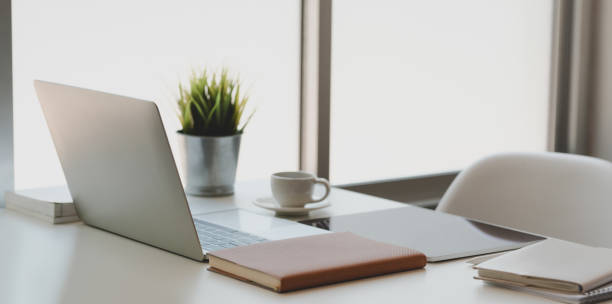 istock Modern workplace next to the windows with laptop computer, tablet and office supplies 1178252879