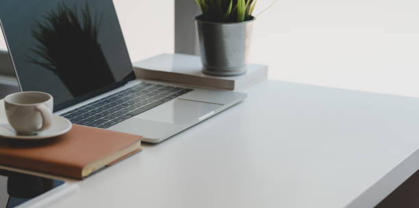 istock Cozy workplace with copy space and laptop computer on white wooden desk 1178252892