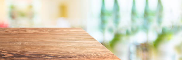 istock wood table top product display background with blur people in green cafe restaurant.left perspective wooden kitchen counter.Banner mockup presentation for your product online 1178253100