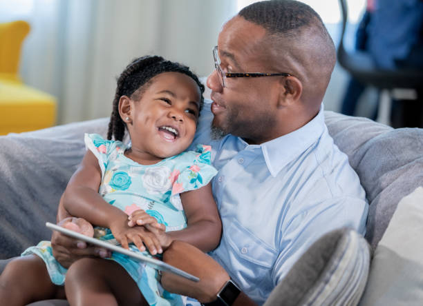 istock Father and daughter bonding on couch 1178253681