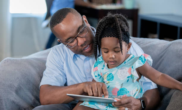 istock Father teaching toddler girl how to use a digital tablet 1178253682