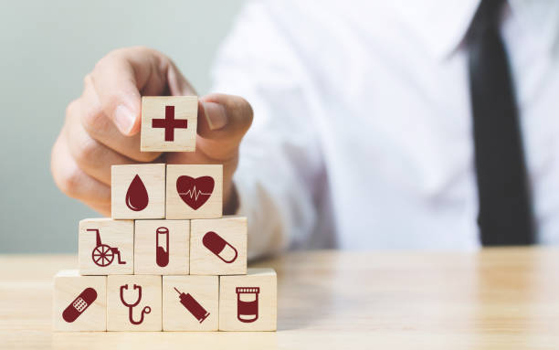 Businessman hand arranging wood block stacking with icon healthcare medical, Insurance for your health concept Businessman hand arranging wood block stacking with icon healthcare medical, Insurance for your health concept patient blood management stock pictures, royalty-free photos & images