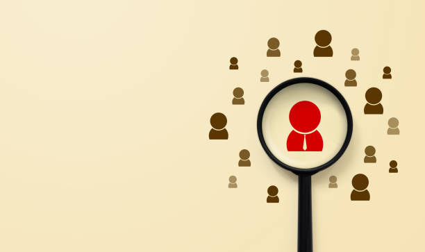 Human resources management and recruitment concept. Magnifying glass is searching for the human icon