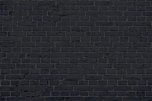 A dark black colored brick wall with rectangular blocks, textured grungy backgrounds. No text. No people, copy space, copyspace. The cemented, cement masonry joints are dark gray grey coloured. The bricks are uneven grunge texture, imperfect.