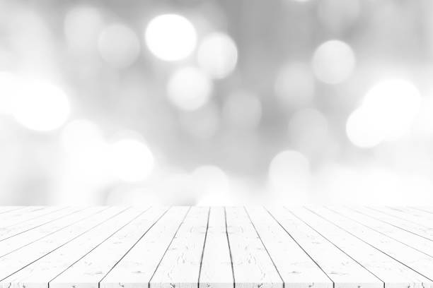 istock Perspective empty white wooden table on top over blur background, can be used mock up for montage products display or design layout. 1178257056