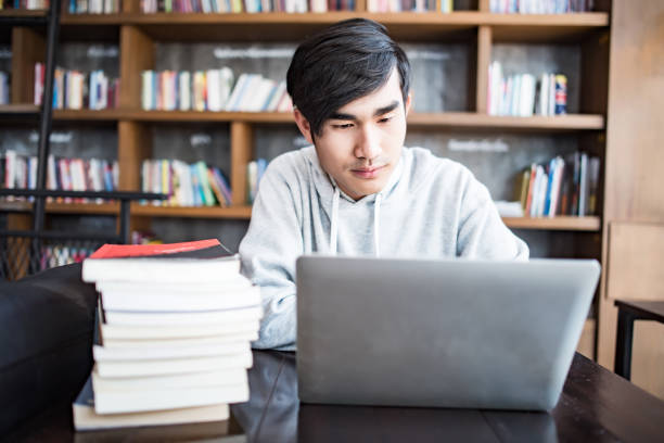 istock Young student man tired of computer sitting at cafe table with laptop 1178261831