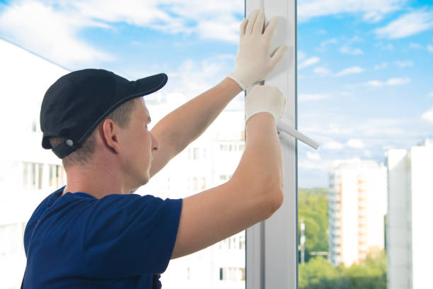 istock worker in blue uniform adjusts the opening of a plastic window against the sky 1178262129