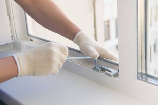 istock hands working in white gloves, adjust the plastic window key, close-up 1178262229