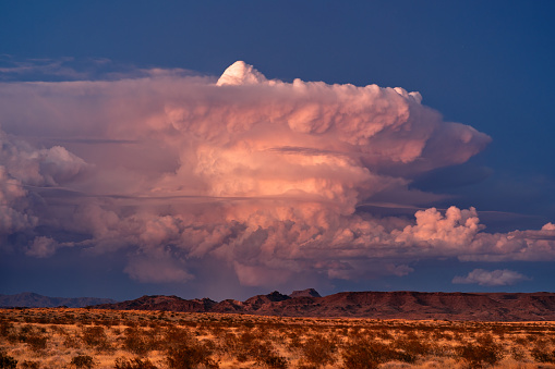 A supercell thunderstorm cumulonimbus cloud with sunset light near Lake Havasu City, Arizona.